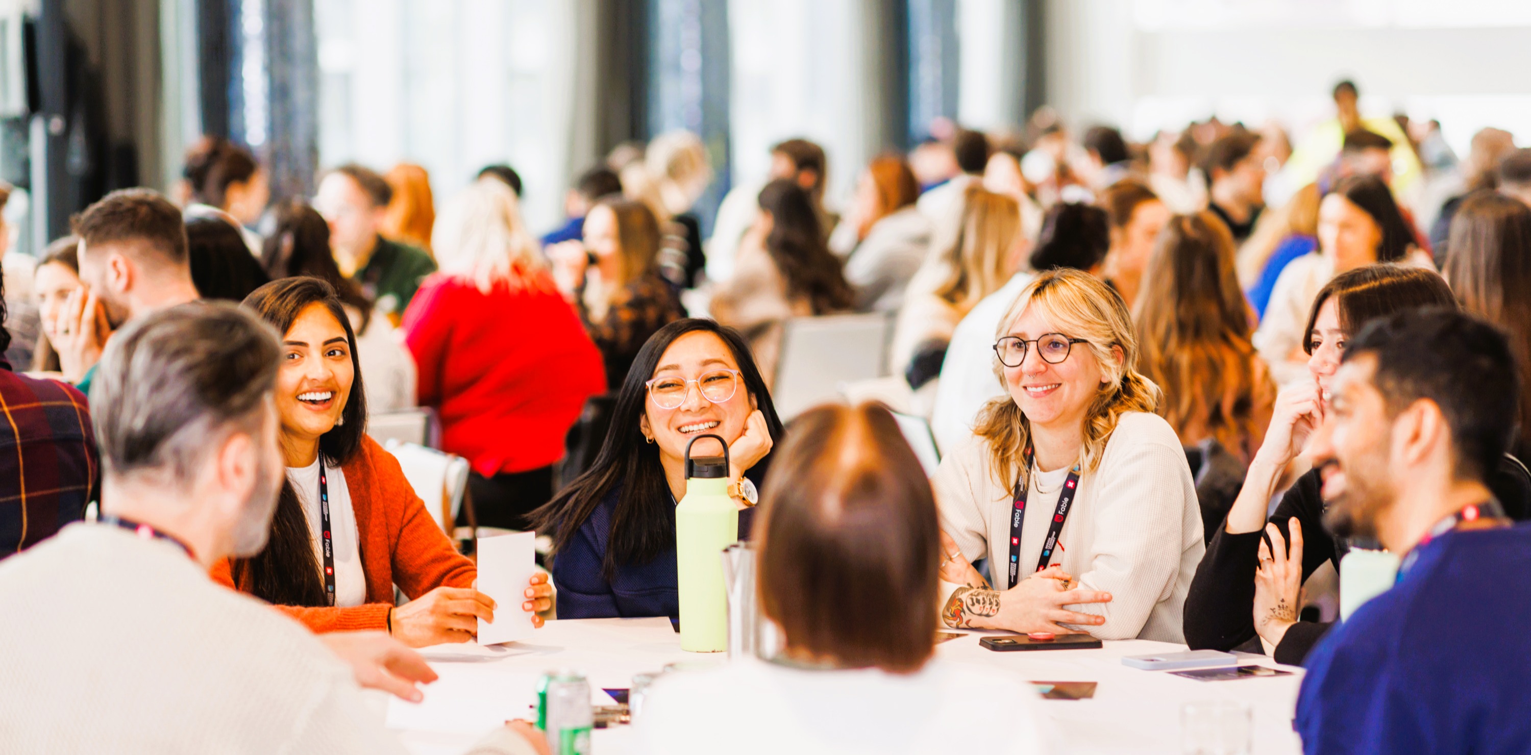 Attendees in conversation at round tables